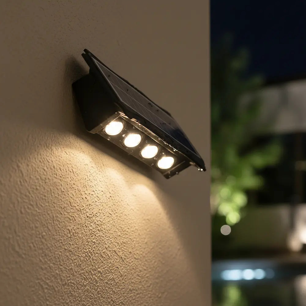 Solar-powered outdoor light fixture on a wall with a blurred background