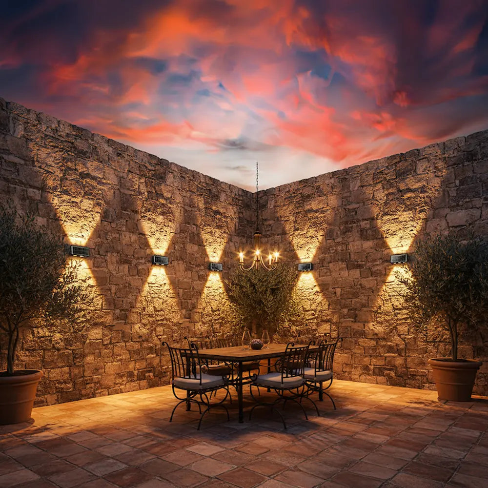 Dining area with stone wall and sunset sky