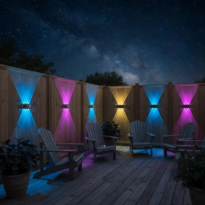 Outdoor seating area with colorful LED lights on a wooden deck under a starry night sky.