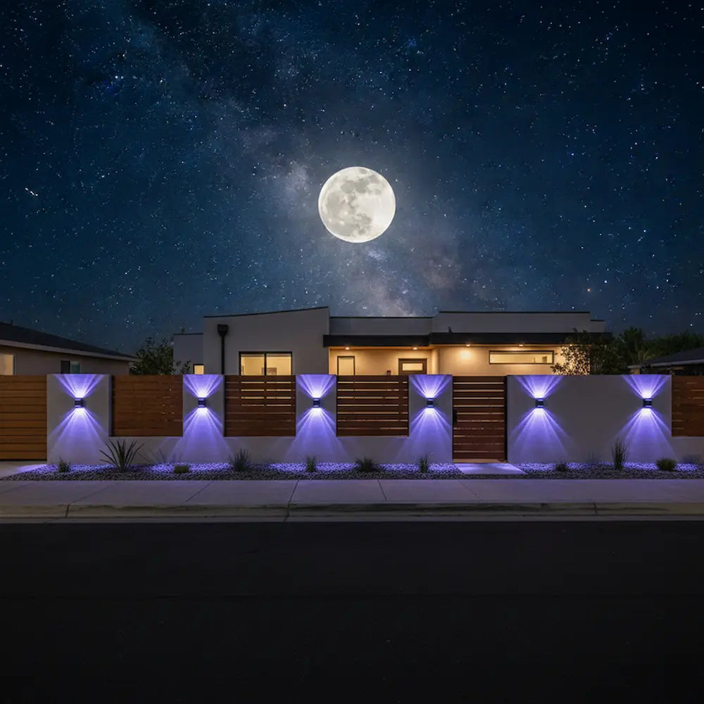 Modern house with illuminated exterior at night under a full moon and starry sky.