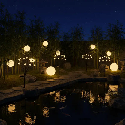 Glowing spherical lights in a garden setting with water and bamboo