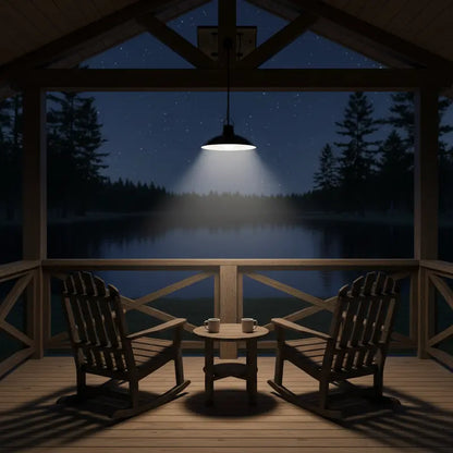 Wooden porch with rocking chairs and a small table under a starry night sky over a lake.