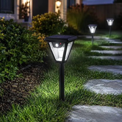 Solar-powered outdoor lights illuminating a garden pathway at night.