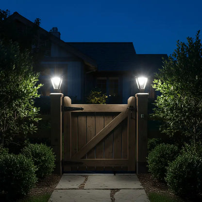 Wooden gate with two outdoor lights on a dark night