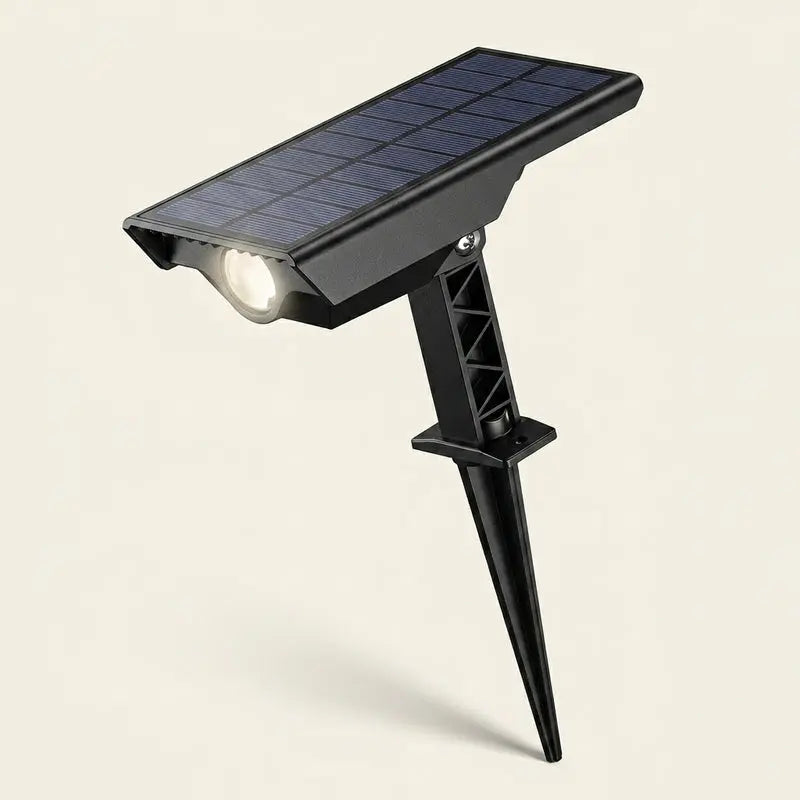 Solar-powered outdoor light with a black spike on a beige background