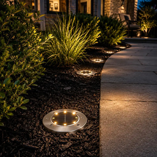 Solar-powered outdoor lights illuminating a garden pathway at night.