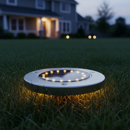 Round solar garden light on grass with house in the background