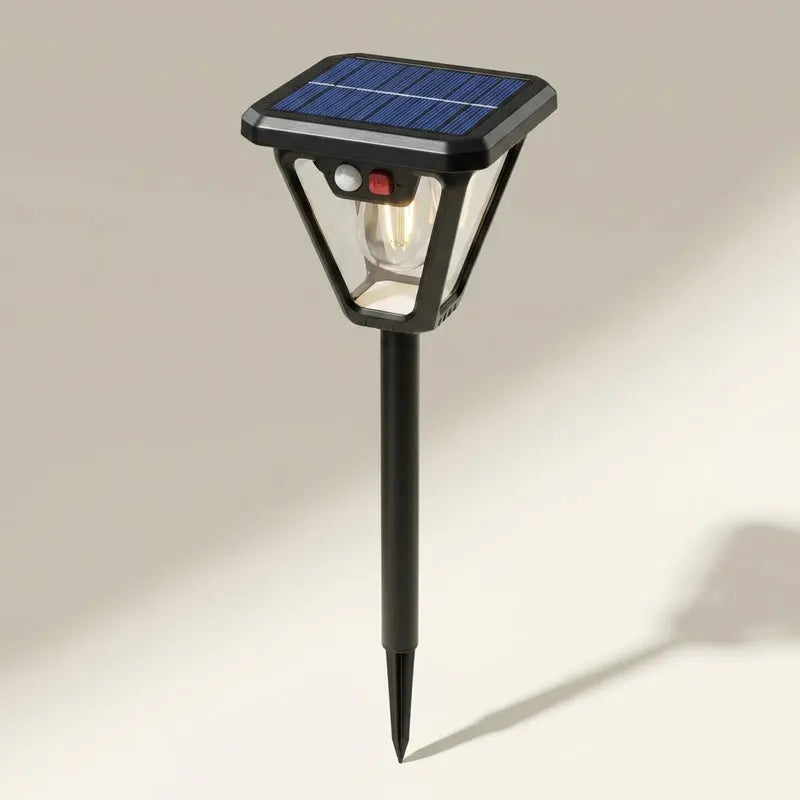Solar-powered outdoor light with a black base and solar panel on a neutral background