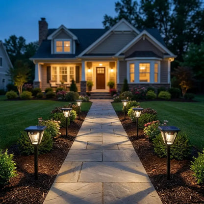 House with a well-lit pathway leading to the front door at night.