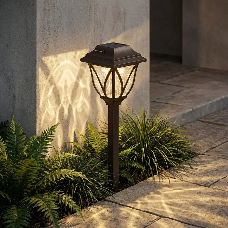 Outdoor garden light fixture on a stone pathway with plants around