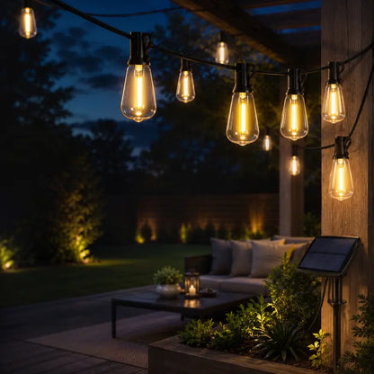 String lights on a patio at night with a couch and outdoor furniture.