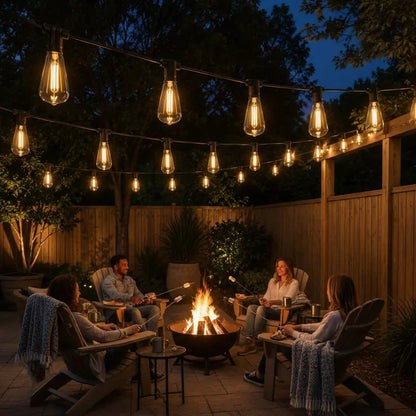 People gathered around a fire pit under string lights in a backyard setting.
