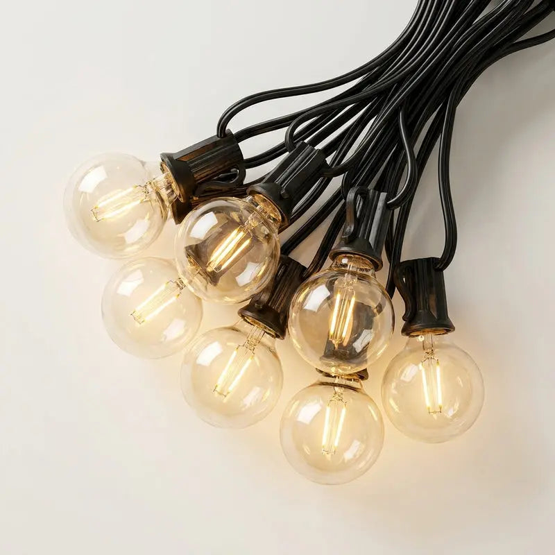 String of clear light bulbs with black wires on a white background