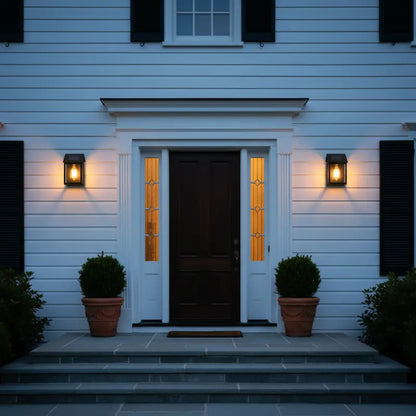 Front door of a house with lights on at night