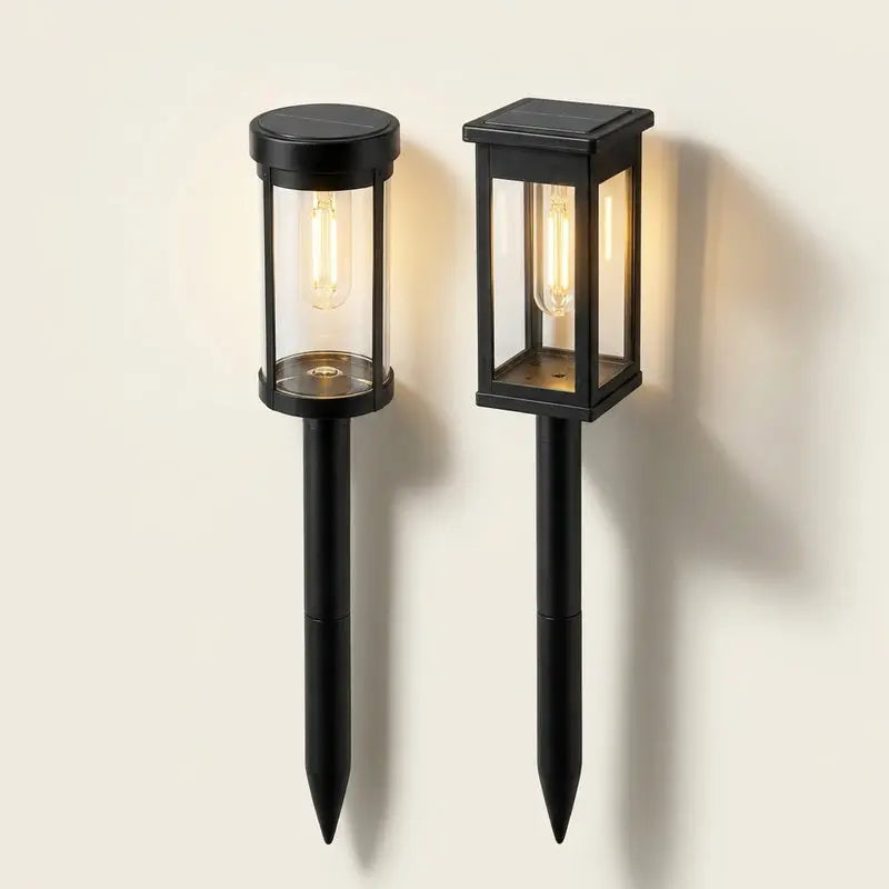 Two black outdoor garden lights on a white background